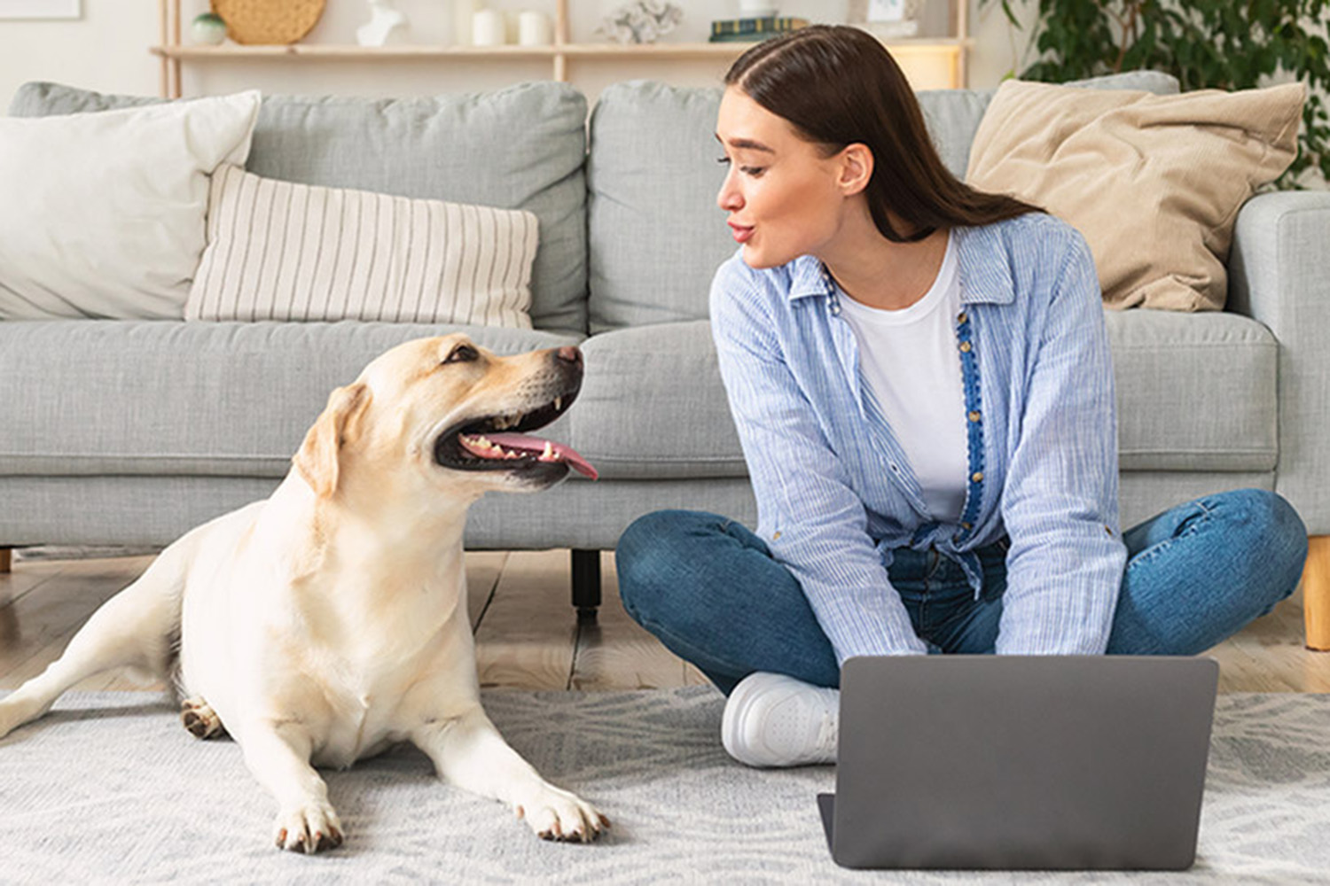 Woman smiling at white dog